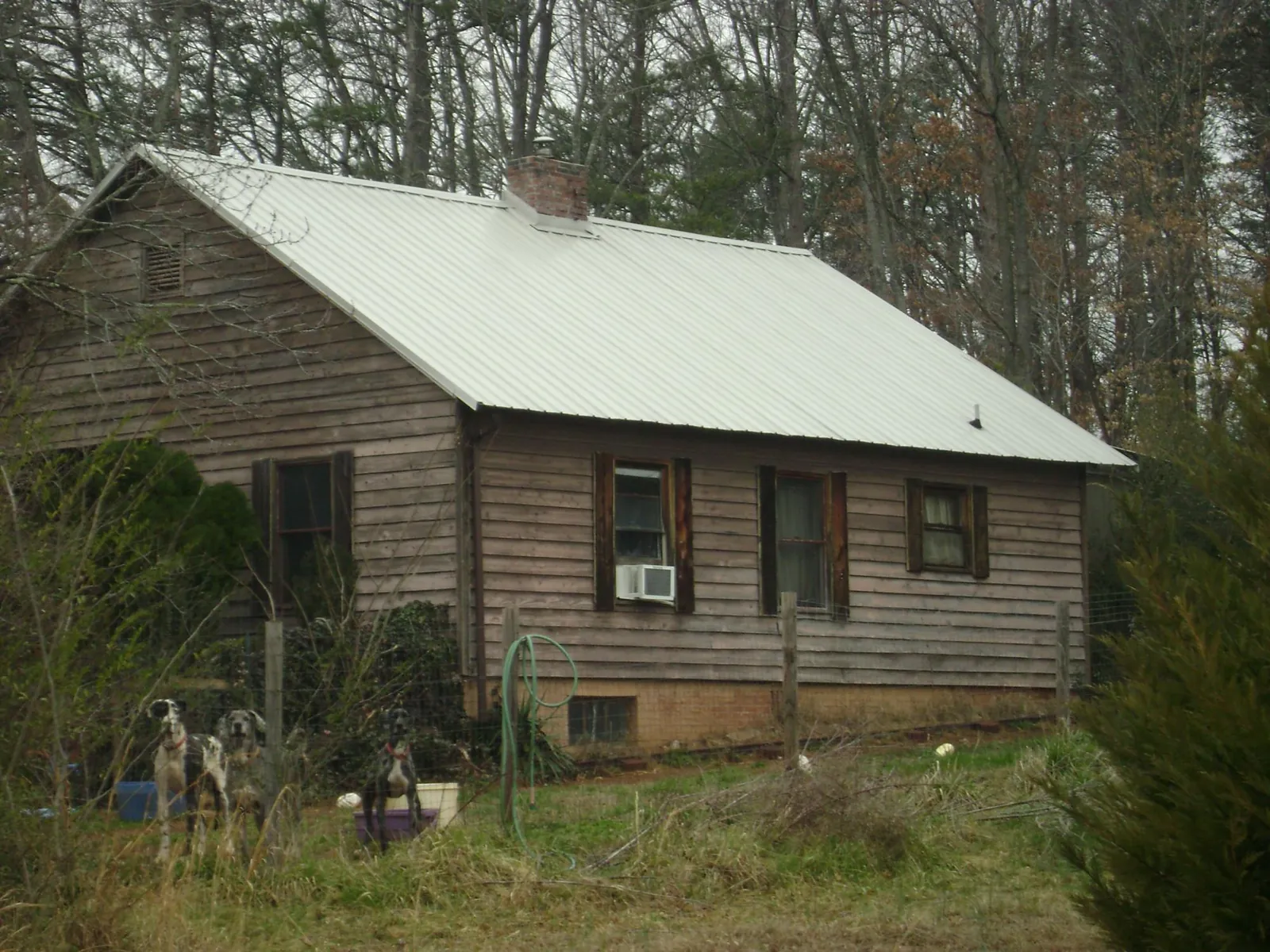 White metal roof on an old wood sided farmhouse, from a Metal Roof Installation job in White Swan